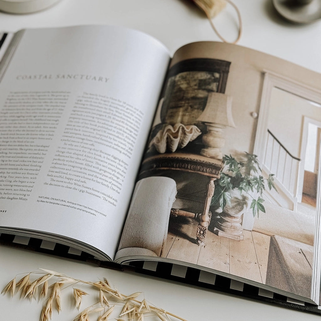 An open book, Create: At Home with Old & New, lies on a table, revealing pages filled with fantastic interior design ideas.