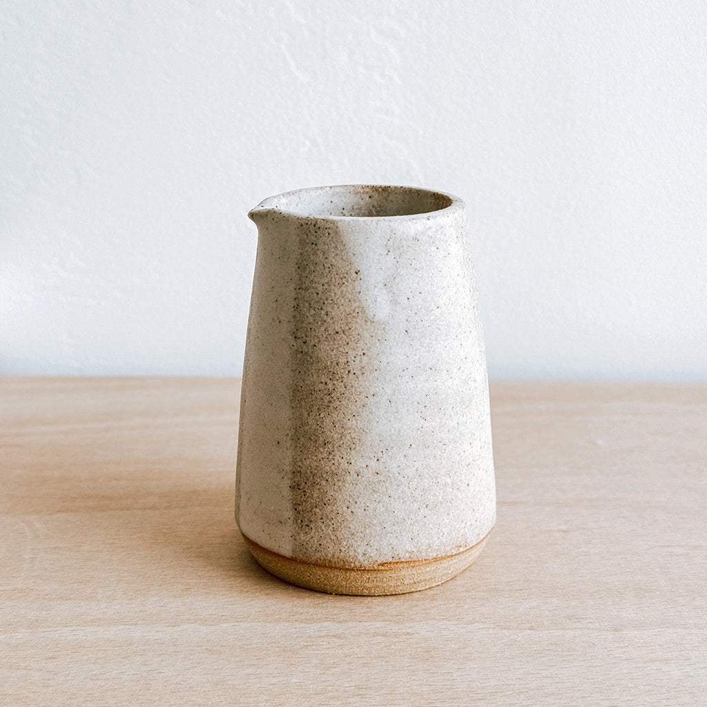 Hand thrown stoneware jug by Clai on a shelf in the byFoke gift studio.