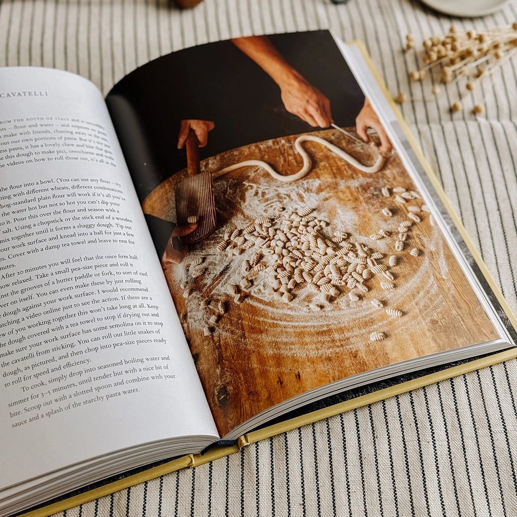 The Farm Table by Julius Roberts, the cook book is laying open showing a photo of home made pasta. byFoke