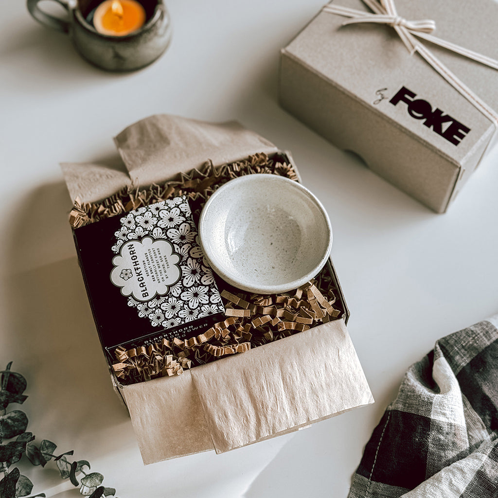 An open byFoke Gift Box containing a mini cream bowl and a box of Blackthorn Sea Salt.