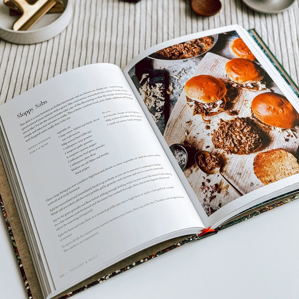 A photo of Sabrina Ghayour's cookbook "Persiana Everyday" lies open on a table, revealing the Sloppy Sabs recipe.