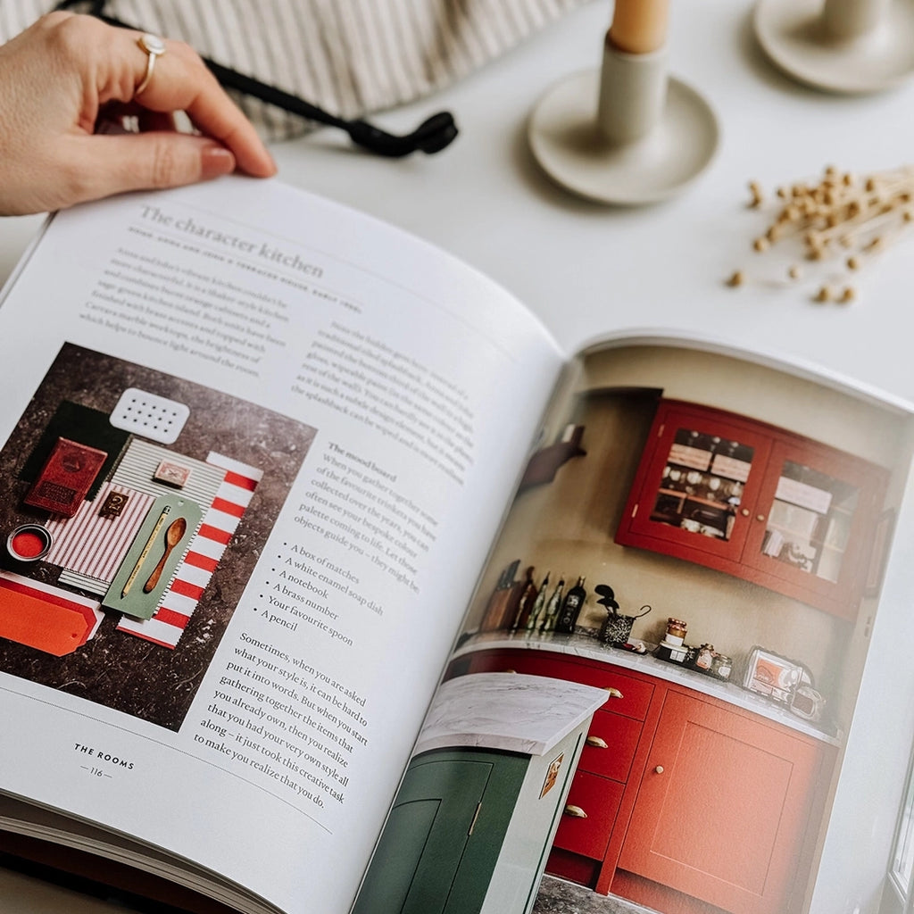 The Home Style Handbook by Lucy Gough, being held open showing a page about character kitchens. byFoke