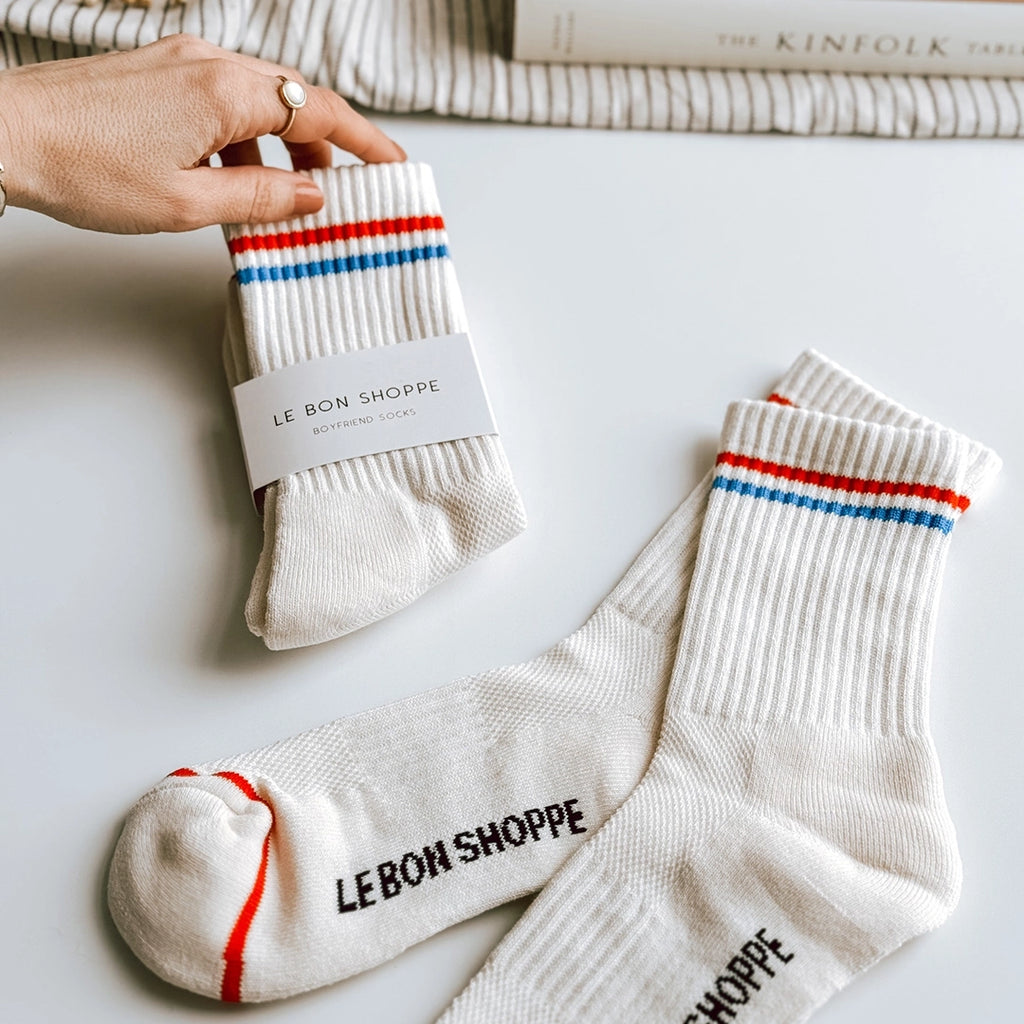 Le Bon Shoppe Boyfriend socks in milk, which is an off-white sock with a red stripe and a blue stripe around the cuff. byFoke.