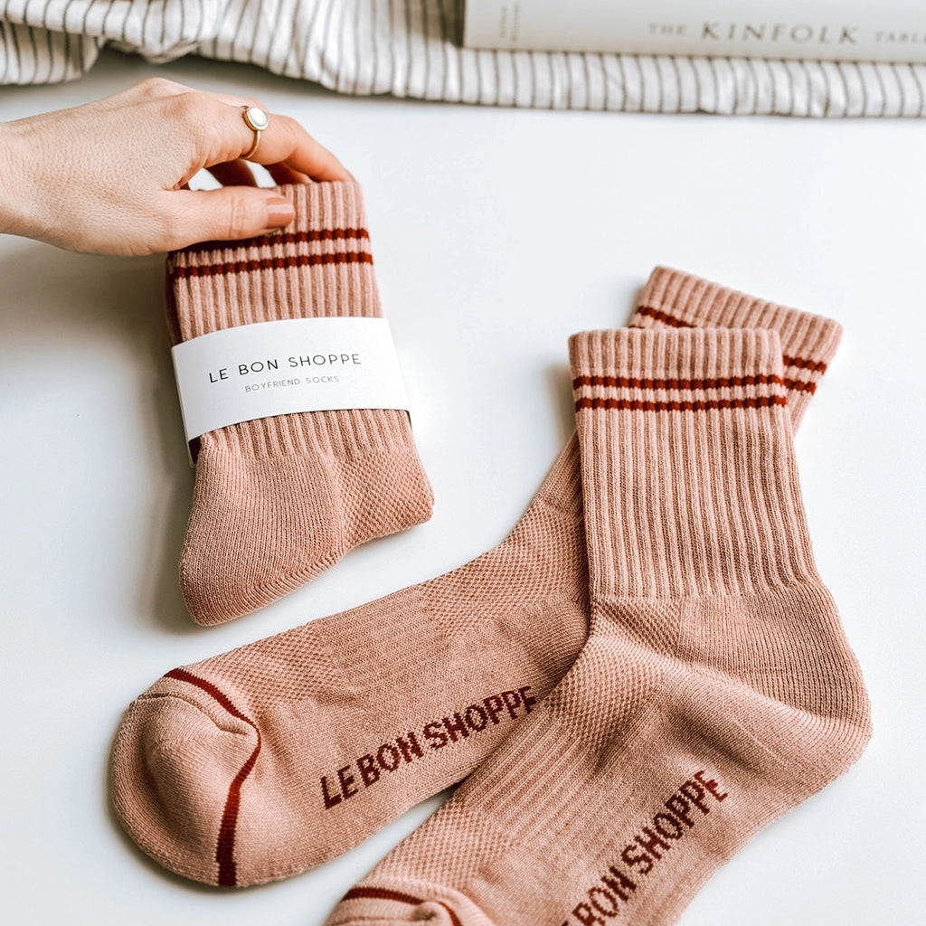 Le Bon Shoppe Boyfriend socks in vintage pink. A woman's hand is holding up one of the pairs of socks. byFoke.