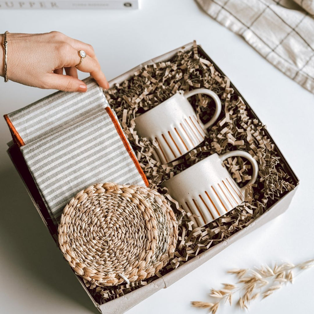 An open byFoke Gift Box, with 2 striped mugs, 2 woven coasters and a pair of striped cotton napkins.