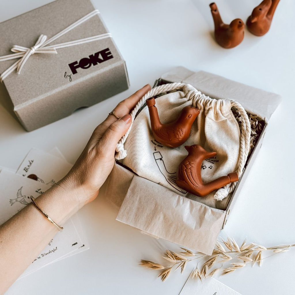 A hand holding an open byFoke Love Birds Gift Box.