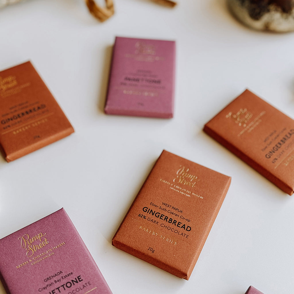 A collection of Pump Street Panettone & Gingerbread Chocolate Bars laying on a table.