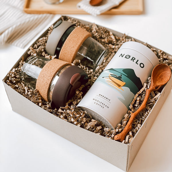 The Farley gift box byFoke containing two Brew Cork KeepCups, a tin of Norlo Coffee with an illustrated front and a hand carved wooden spoon