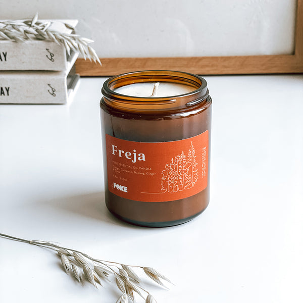 A byFoke Freja essential oil, soy wax candle. The candle is in a apothecary jar with an illustrated label.