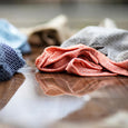 A kitchen counter showing a collection of The Organic Company's kitchen wash cloths being used.